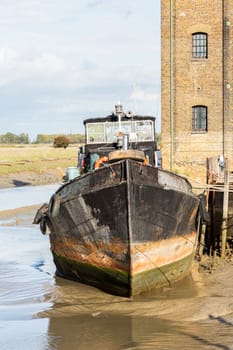 Thames sailing ship or houseboat by dock in Faversham Kent UK