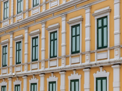 European style yellow building with green window