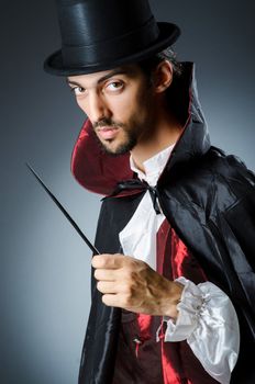 Magician doing tricks in dark room