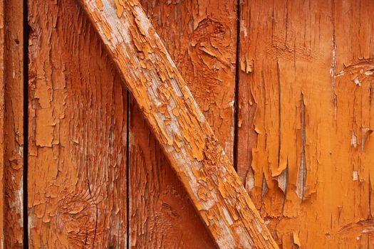 Peeled paint falling off old wooden door