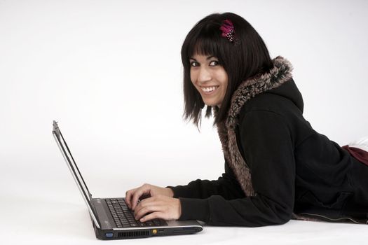 A colorful woman works on the laptop