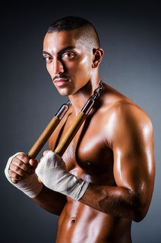 Strong man with nunchaku