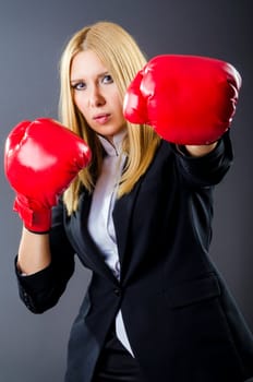 Woman boxer in dark room