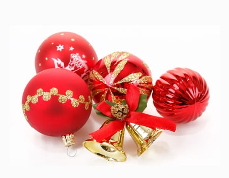 Red christmas balls and small golden bells on white