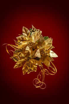 christmas decoration with golden flower on red background