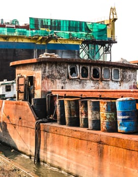 The abandoned old rusty ship in the shipyard