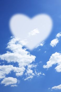 Love concept. Blank white heart shape against bly sky with clouds