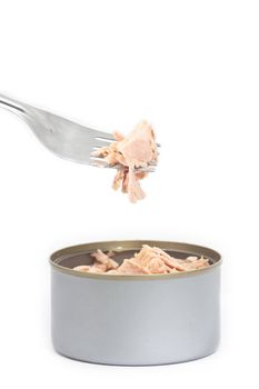 Tuna in vegetable oil with fork on white
