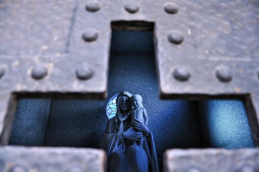 A statue of the Virgin Mary with Baby Jesus in a tomb in Buenos Aires, Argentina