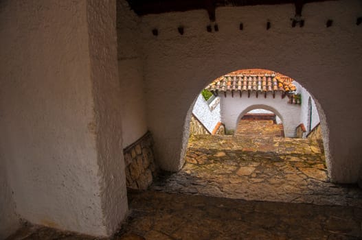 A white passageway in a colonial Colombian town