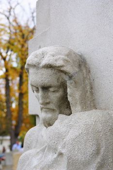 stone statue of jesus at a grave