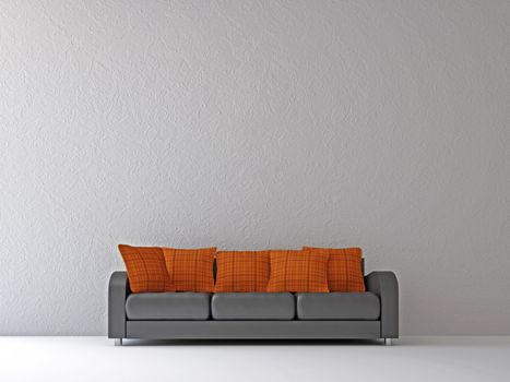 Sofa with orange pillows near the wall
