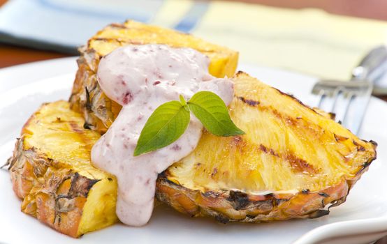 Grilled pineapple topped with a raspberry infused cream.