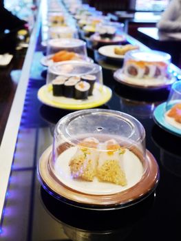 sushi belt with sushi dishes in a sushi bar