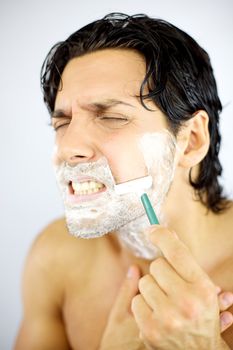 Handsome man fear of shaving with blade