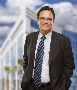 Handsome Businessman in Suit and Tie Smiling Outside of Corporate Building.