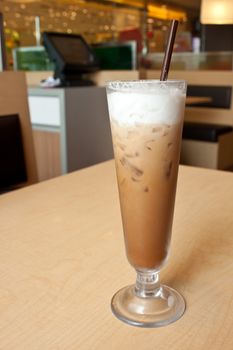 Ice coffee in the glass on the wood table