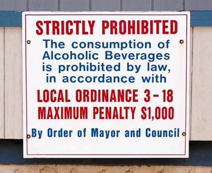 A sign stating that alcohol consumption is prohibited due to a local ordinance.