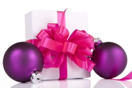 White present with pink ribbons and purple ornaments, isolated