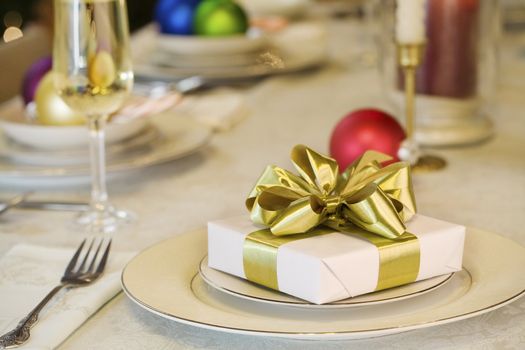 Gold ribbon gift on dining table, as Christmas theme decorations