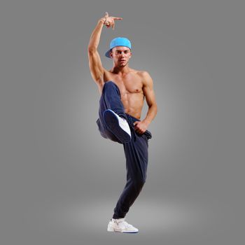 dancer of hip-hop on a gray background , motion