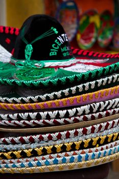 A stack of festive sombreros at a market stall in Mexico