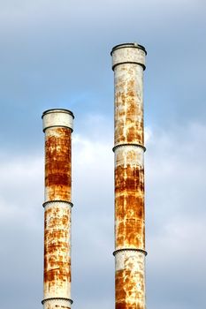 Rusty metal chimneys of a factory