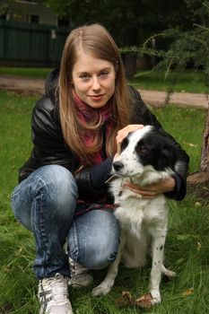 Young woman with dog in the autumn park