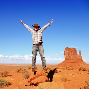 cheerful cowboy in monument Valley, Arizona, USA