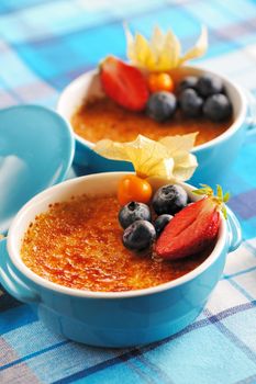 Creme brulee (cream brulee, burnt cream) with fruits and berries