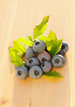 Blueberry with leafs on wooden table