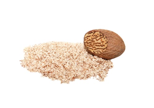 Grated nutmeg and whole nutmeg with grated face, isolated on a white background