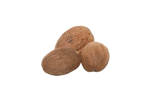 Three whole nutmeg, isolated on a white background