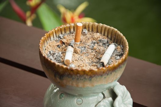 ashtray with cigarettes and sand