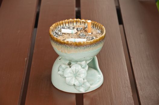 ashtray with cigarettes and sand