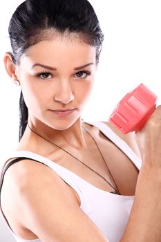 Cute and young girl do exercises with red dumbbells