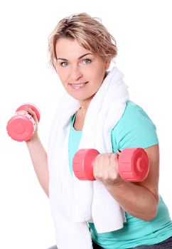 Cute mid aged women with towel do exercises with dumbbells ona a ball