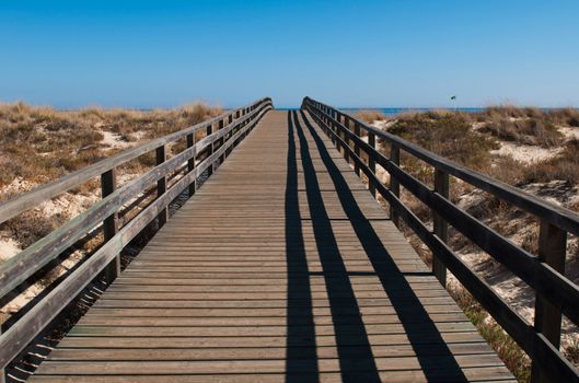 stunning wooden walkway on a sandy beach in Manta Rota (Algarve), Portugal