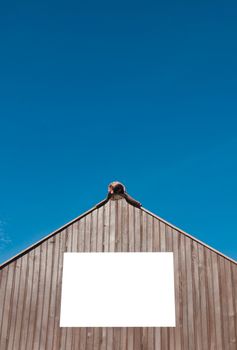 squared billboard on wooden structure (isolated on white) against a blue sky background