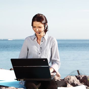 woman with laptop sea background