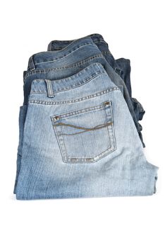 Three old and worn blue jeans isolated over a white background