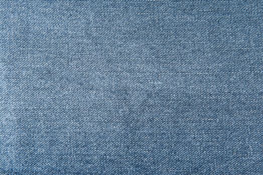 Old and worn blue jeans pattern background in a king size
