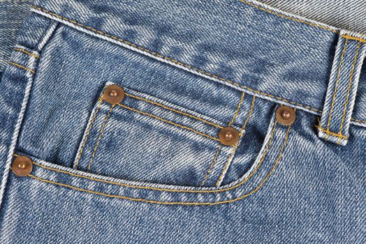 Closeup from the pocket of an old and worn blue jeans