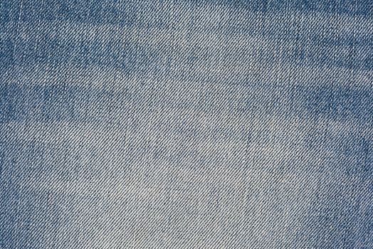 Old and worn blue jeans pattern background in a king size
