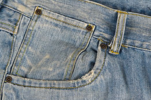 Closeup from the pocket of an old and worn blue jeans