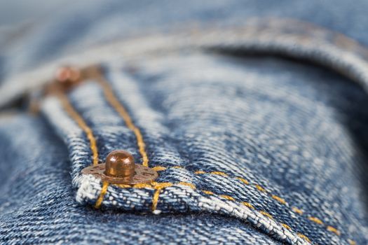 Closeup from the pocket of an old and worn blue jeans