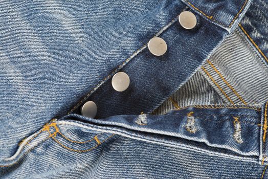 Detail of the fly of the jeans with button closure