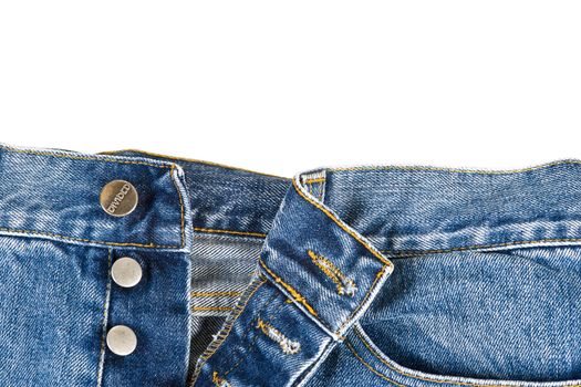 Fly of the blue  jeans with button closure over a white background