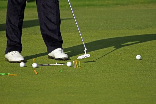 Pro golfer set up for practicing his putting stance