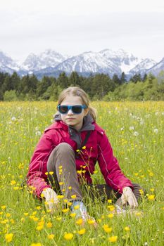 portrait of a girl against the panorama of the Alps